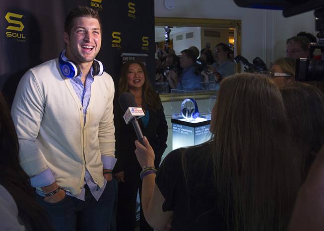 NFL quarterback Tim Tebow reacts to a reporter's question during at a news conference to promote the Tim Tebow Signature Series headphones by Soul Electronics at the 2013 International CES Thursday, Jan. 10, 2013.