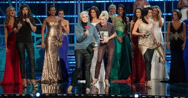 1955 Miss America Lee Meriwether, center, holds a rose for Chris Harrison during the second night of preliminaries in the 2013 Miss America Pageant at PH Live in Planet Hollywood on Wednesday, Jan. 9, 2013.