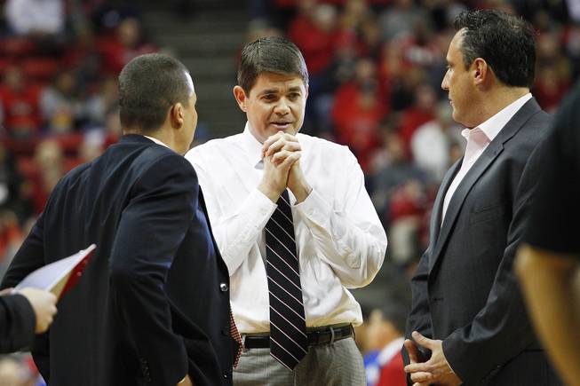 UNLV head coach Dave Rice talks with assistants Justin Hutson, left, and Heath Schroyer during a time out in their game against Air Force Saturday, Jan. 12, 2013 at the Thomas & Mack. UNLV won in overtime, 76-71.