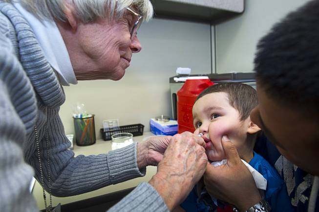 Nurse Ella Duhaime give a FluMist vaccine to Jose Menchaca, 2, at the Southern Nevada Health District, 330 S. Valley View Blvd., on Monday, Jan. 14, 2013. The FluMist vaccine is a needle-free vaccine in the form of a nasal spray.