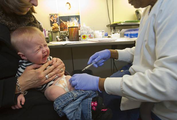 Brookelynn Drake, 7 months, cries after getting a flu shot at Southern Nevada Health District, 330 S. Valley View Blvd., on Monday, Jan. 14, 2013.