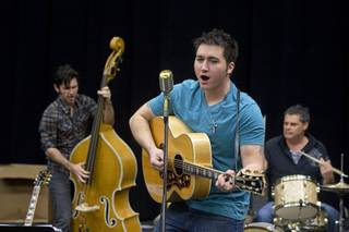 Tyler Hunter, center, performs as Elvis Presley during a rehearsal for 