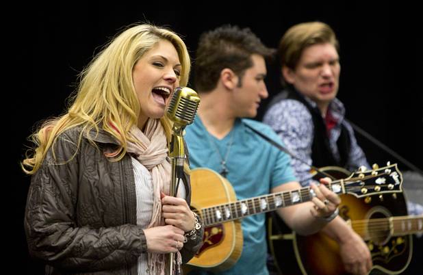 Felice Garcia sings during a rehearsal for "Million Dollar Quartet" in a warehouse near The Orleans on Tuesday, Jan. 15, 2013. In the background are Tyler Hunter, center, as Elvis Presley and Benjamin D. Hale as Johnny Cash. "Million Dollar Quartet" is based on a performance by Johnny Cash, Jerry Lee Lewis, Carl Perkins and Elvis Presley at Sun Records in Memphis on Dec. 4, 1956. The new show begins at Harrah's Las Vegas on Feb. 4.