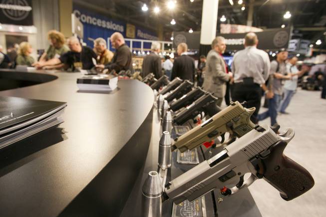 Sig Sauer handguns are displayed during the annual SHOT (Shooting, Hunting, Outdoor Trade) Show in the Sands Expo Center Tuesday, Jan. 15, 2013. Gun dealers at the show are reporting booming sales resulting from worries about possible gun control legislation. STEVE MARCUS