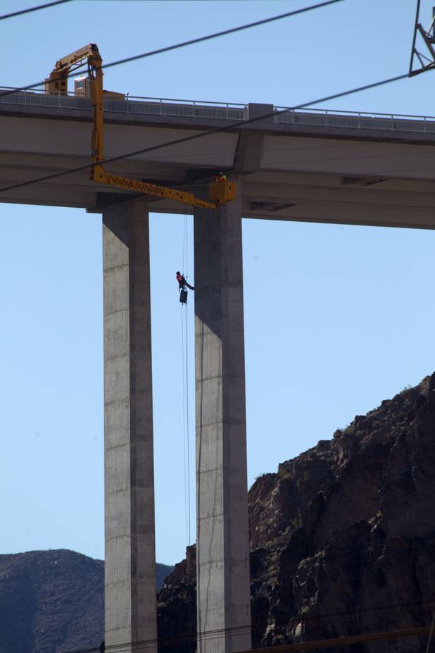 A bridge inspector rappels down a column during a safety inspection of the Mike O'Callaghan-Pat Tillman Memorial Bridge Wednesday, January 16, 2013.