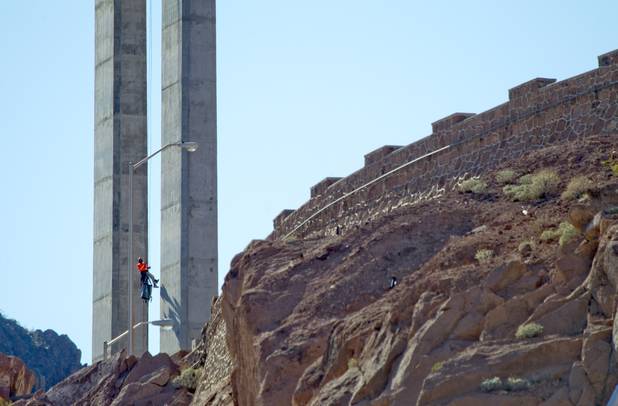 A bridge inspector rappels down a column during a safety inspection of the Mike O'Callaghan-Pat Tillman Memorial Bridge Wednesday, January 16, 2013.