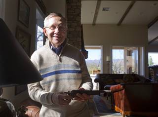 Senate Majority Leader Harry Reid (D-NV) holds a rusted pistol after an interview at his home in Searchlight, Nev. Thursday, January 17, 2013.