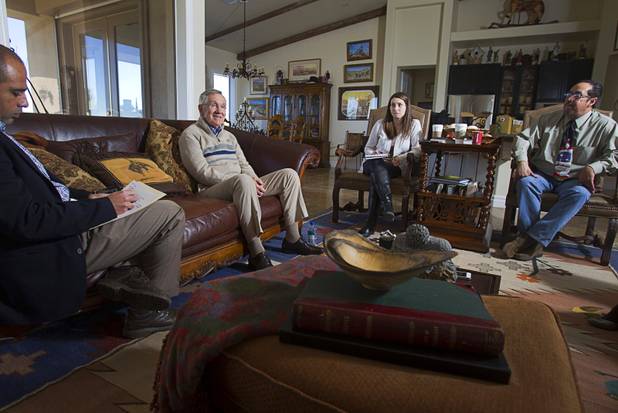 Senate Majority Leader Harry Reid (D-NV) responds to questions during an interview with reporters at his home in Searchlight, Nev. Thursday, January 17, 2013. With Reid are Kristen Orthman, center, Reid's Nevada communications director, and Eddie Escobedo Jr., publisher of the El Mundo.