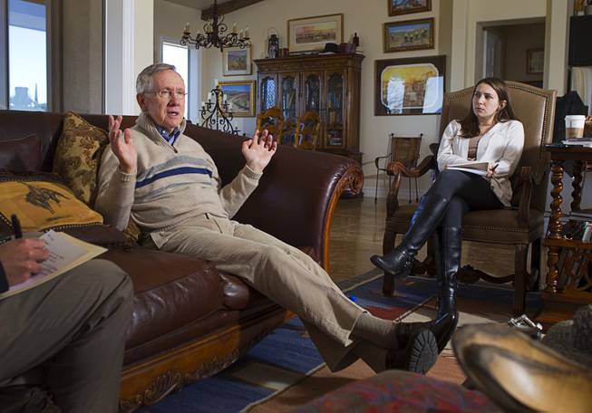 Senate Majority Leader Harry Reid (D-NV) responds to questions during an interview with reporters at his home in Searchlight, Nev. Thursday, January 17, 2013. Kristen Orthman, Reid's Nevada communications director, listens at right.