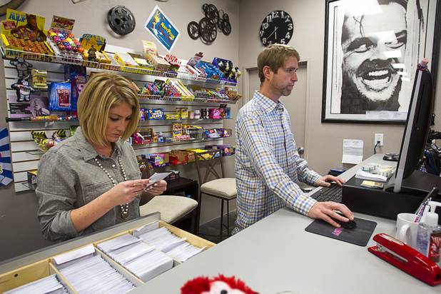 Trevor Layne and his girlfriend Katie Crispell work at the counter at Movies & Candy, 10895 S. Eastern Ave., Thursday, January 17, 2013. Layne opened the video shop last November when his house started overflowing with movies.
