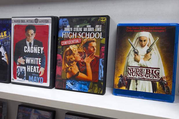 "Nude Nuns with Big Guns," a 2010 nunsploitation thriller film, is displayed at Movies & Candy, 10895 S. Eastern Ave., Thursday, January 17, 2013. Movie fan Trevor Layne opened the video shop last November when his house started overflowing with movies.