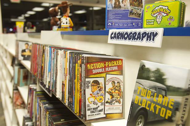 Car-themed movies are displayed in the "Carnography section at Movies & Candy, 10895 S. Eastern Ave., Thursday, January 17, 2013. Movie fan Trevor Layne opened the video shop last November when his house started overflowing with movies.