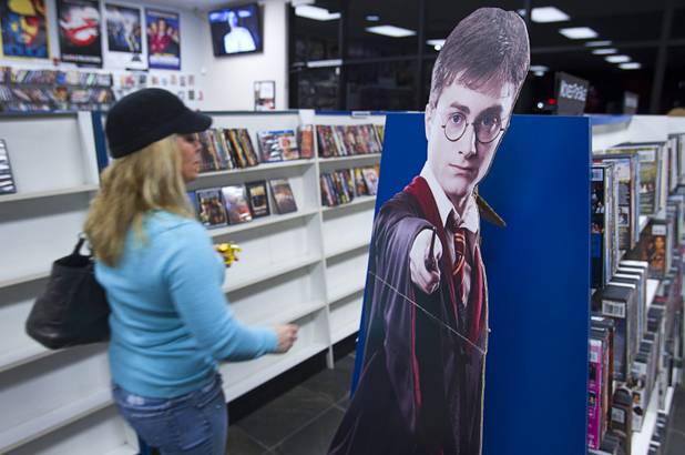 A cardboard cut-out of Harry Potter appears to cast a spell at Movies & Candy, 10895 S. Eastern Ave., Thursday, January 17, 2013. Movie fan Trevor Layne opened the video shop last November when his house started overflowing with movies.