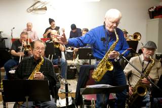 Roger Hall, 87, conducts fellow musicians while performing an alto sax solo during the Thursday Night Band jam session in The Garage in Henderson Thursday, January 18, 2013.