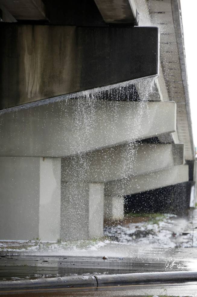 Runoff water from melting snow makes a waterfall from an overpass along I-55 in Jackson, Miss., Thursday,  Jan. 17, 2013.  A winter storm system left 2 to 4 inches of snow in parts of central Mississippi before heading east toward Alabama, the National Weather Service said. 