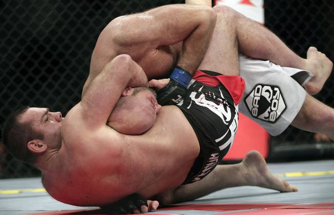Gabriel Gonzaga, from Brazil, bottom, chokes Ben Rothwell, from the U.S, during their heavyweight mixed martial arts bout at the Ultimate Fighting Championship (UFC) in Sao Paulo, Brazil, Saturday, Jan. 19, 2013.