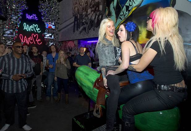 Adult film actresses Kleio, left, Veruca James, center, and Jessie Lee ride a mechanical pickle during the second annual Burning Angel porn brunch at the Rattlecan restaurant in the Venetian Sunday, Jan. 20, 2013. The brunch follows the AVN Adult Entertainment Expo which ended Saturday. About 40 guests joined adult film actresses as they downed signature "Pickleback" shots and rode the mechanical pickle, a concept inspired by the 2012 brunch.