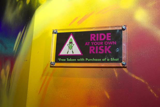 A disclaimer is posted by a mechanical pickle ride during the second annual Burning Angel porn brunch at the Rattlecan restaurant in the Venetian Sunday, Jan. 20, 2013. The brunch follows the AVN Adult Entertainment Expo which ended Saturday. About 40 guests joined adult film actresses as they downed signature "Pickleback" shots and rode the mechanical pickle, a drink concept that was inspired at the 2012 brunch.
