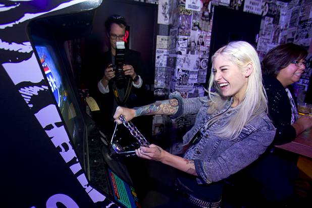 Adult film actress Kleio clowns around with a driving game during the second annual Burning Angel porn brunch at the Rattlecan restaurant in the Venetian Sunday, Jan. 20, 2013. The brunch follows the AVN Adult Entertainment Expo which ended Saturday. About 40 guests joined adult film actresses as they downed signature "Pickleback" shots and rode a mechanical pickle, a drink concept that was inspired at the 2012 brunch.