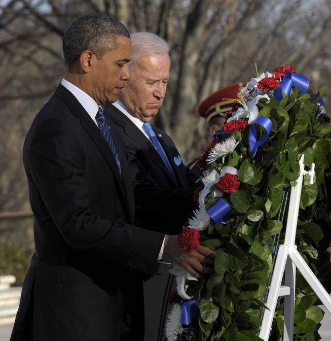 President Barack Obama and Vice President Joe Biden place a wreath at the Tomb of the Unknowns at Arlington National Cemetery in Arlington, Va., Sunday, Jan. 20, 2013.