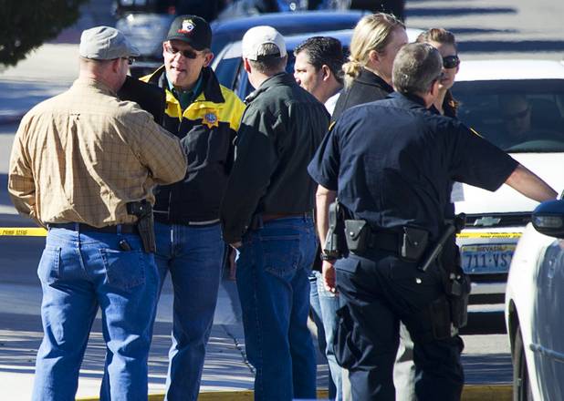 Law enforcement officials confer during a shooting investigation in Boulder City, Jan. 21, 2013.
