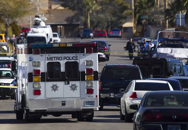 Law enforcement officials investigate a shooting in Boulder City, Jan. 21, 2013.