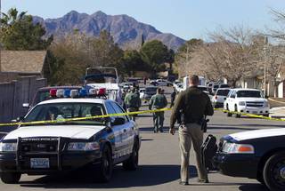 Law enforcement officials investigate a shooting in Boulder City, Jan. 21, 2013.
