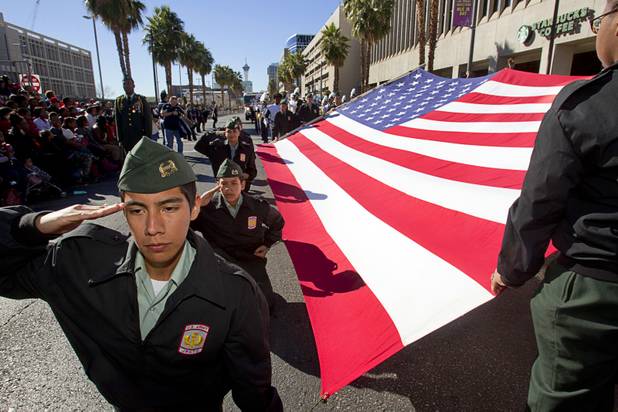 Javier Amezcua, left, and other members of the Cheyenne High School Army Jr. ROTC program, display a flag during the 31st annual Martin Luther King Jr. parade in downtown Las Vegas, Monday, Jan. 21, 2013. MGM Resorts International was the presenting sponsor for the event.