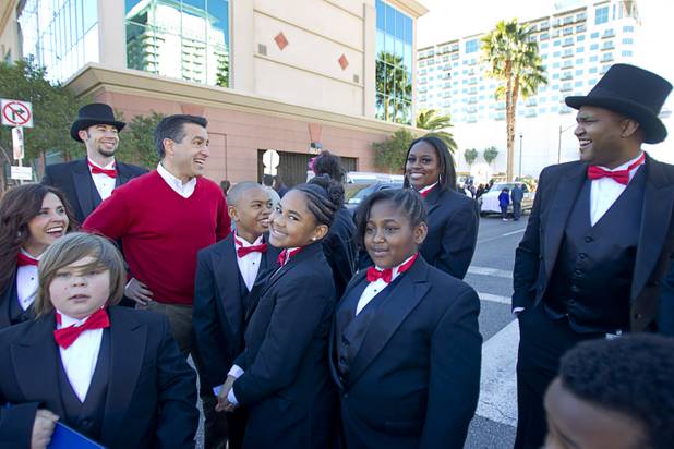 Nevada Governor Brian Sandoval, left, chats with members of Wendell Williams Elementary School entry before the start of the 31st annual Martin Luther King Jr. parade in downtown Las Vegas, Monday, Jan. 21, 2013. MGM Resorts International was the presenting sponsor for the event.