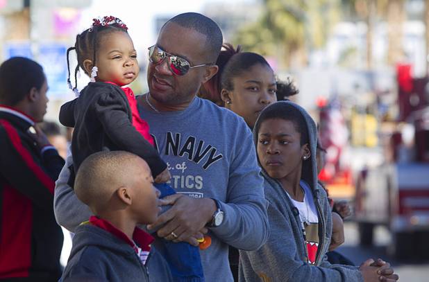 Alexis Marentic, 2, watches with her father Anthony during the 31st annual Martin Luther King Jr. parade in downtown Las Vegas, Monday, Jan. 21, 2013. MGM Resorts International was the presenting sponsor for the event.