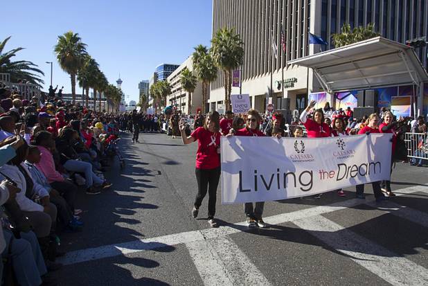 Members of the Caesars Entertainment/Caesars Foundation entry march in the 31st annual Martin Luther King Jr. parade in downtown Las Vegas, Monday, Jan. 21, 2013. MGM Resorts International was the presenting sponsor for the event.