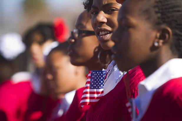 Parade participants wear American flags during the 31st annual Martin Luther King Jr. parade in downtown Las Vegas, Monday, Jan. 21, 2013. MGM Resorts International was the presenting sponsor for the event.