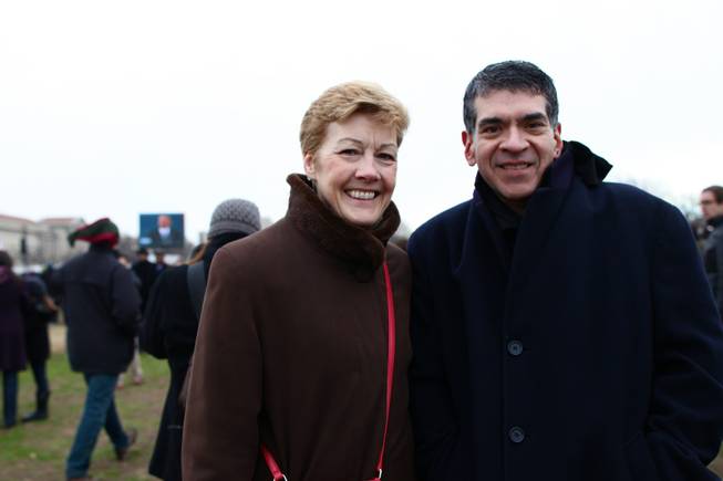 Jane Irwin and Bob Romo of Chicago on the National Mall, with a projection screen of President Barack Obama in the background, on Inauguration Day, Monday, Jan. 21, 2013.