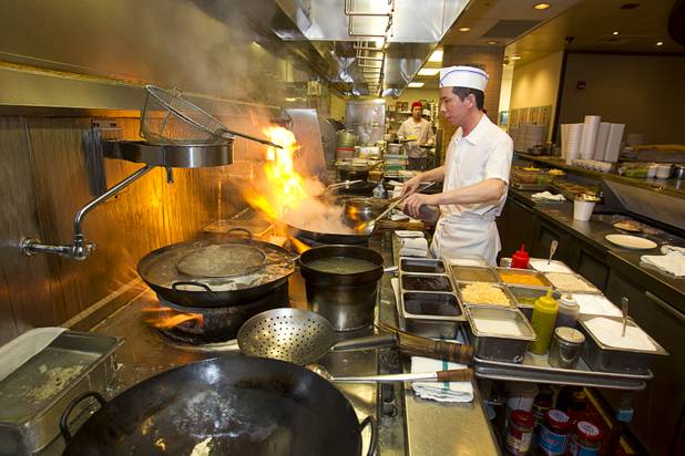 A chef prepares a dinner order at Ping Pang Pong in the Gold Coast Tuesday, Jan. 22, 2013.