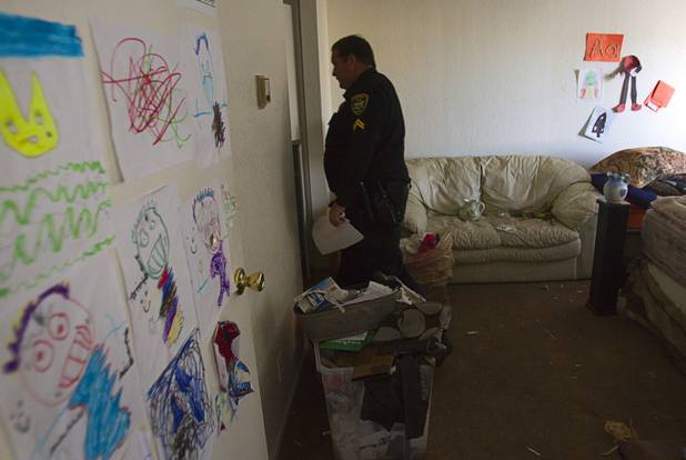 Deputy Constable Patrick Geary looks through an apartment during an eviction in the southwest part of the Las Vegas Valley Tuesday, Jan. 22, 2013. The resident had already moved out.