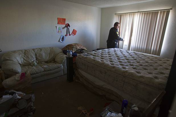 Deputy Constable Patrick Geary checks that windows in an apartment are secure during an eviction in the southwest part of the Las Vegas Valley Tuesday, Jan. 22, 2013. The resident had already moved out.