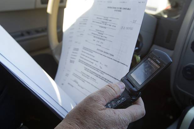 Deputy Constable Patrick Geary makes a call to set up an eviction in the southwest part of the Las Vegas Valley Tuesday, Jan. 22, 2013.