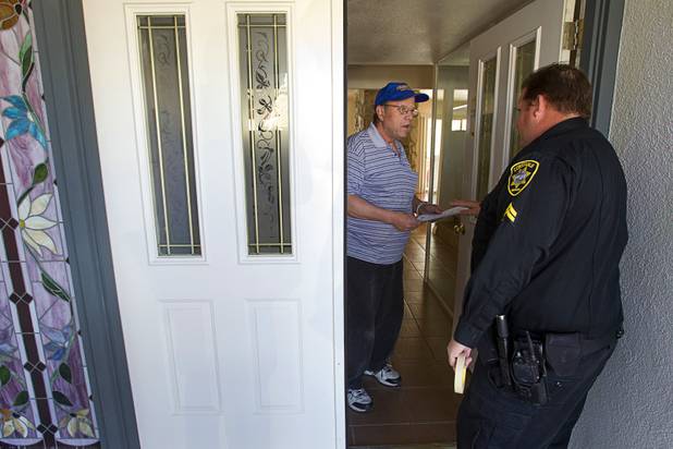 Ed Lukarski talks with Deputy Constable Patrick Geary after being served with a 24-hour eviction notice Tuesday, Jan. 22, 2013. The homeowner had allowed Lukarski to stay in the home while he was working for her but evicted him after he complained to the labor board about his pay, he said.