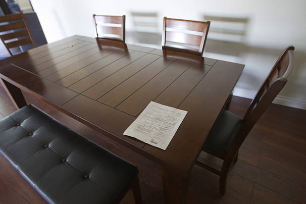 A 24-hour eviction notice is shown on a table during an eviction at a furnished apartment near Desert Inn Road and Joe W. Brown Drive Tuesday, Jan. 22, 2013. The resident had already moved out.