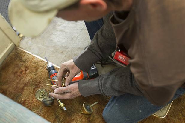 Maintenance man Mark Weaver changes the lock on an apartment near Karen Avenue and Joe W. Brown Drive Tuesday, Jan. 22, 2013.