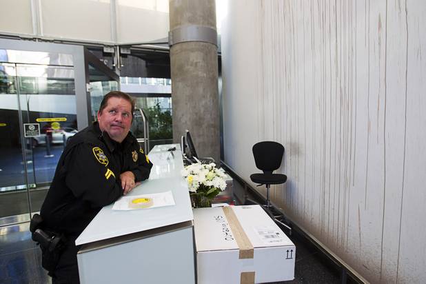 Deputy Constable Patrick Geary waits at the front desk of the Veer Towers before posting an eviction notice Tuesday, Jan. 22, 2013.