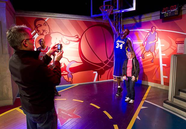 Al Brischuk of Canada takes a photo of his wife Cathy by a wax figure of NBA star Shaquille O'Neal at Madame Tussauds Las Vegas wax attraction in the Venetian Wednesday, Jan. 23, 2013. On Thursday, the museum will unveil a wax figure of actress Sandra Bullock.