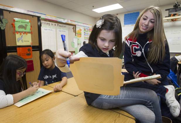 Coronado High School cheerleader Kayla Wilson helps second-grader Rylan Aspeland with a grammar worksheet at Glen Taylor Elementary School in Henderson on Wednesday, Jan. 23, 2013. Coronado basketball players and cheerleaders take time out of their season to mentor first- and second-graders at the school.
