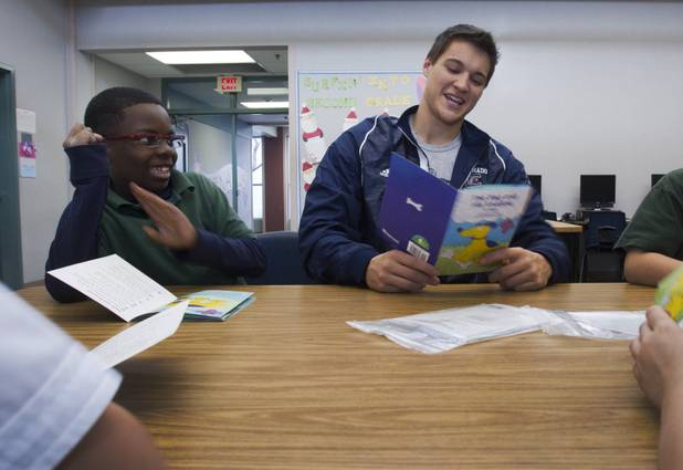 Coronado High School basketball player Charlie Teixeira reads a story with Devon Lewis, left, and other second-graders at Glen Taylor Elementary School in Henderson on Wednesday, Jan. 23, 2013. Coronado basketball players and cheerleaders take time out of their season to mentor first- and second-graders at the school.