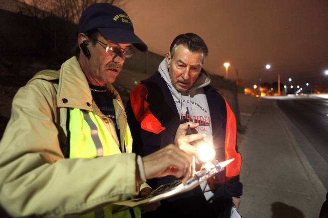 Guide Neil Jurgensen, left, helps volunteer Ken LoBene, director of the Las Vegas office of Housing and Urban Development, during a census of the homeless in Clark County in downtown Las Vegas early in the morning on Thursday, January 24, 2013.