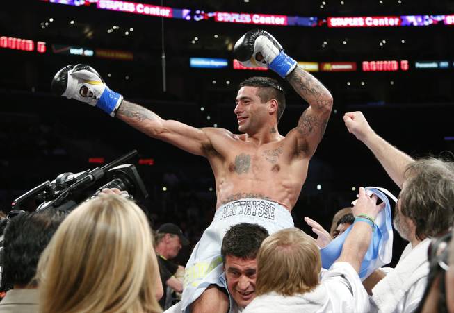 Lucas Matthysse, top, of Argentina, celebrates his TKO victory against Humberto Soto, of Mexico, after a WBC lightweight boxing match in Los Angeles, Saturday, June 23, 2012. Matthysse won by TKO in the fifth round.