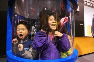 Ethan Kwok screams while his sister Grace Kwok giggles in a hurricane simulator at Lied Discovery Children's Museum Saturday, Jan. 26, 2013.