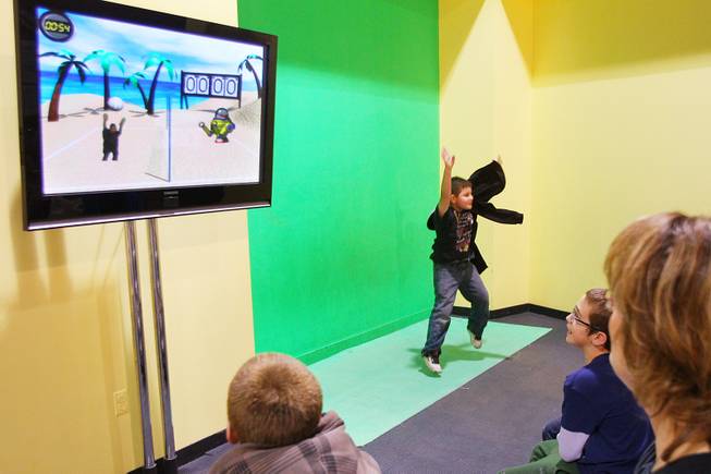 Christopher Leafdale interacts with a green screen and volleyball game at Lied Discovery Children's Museum Saturday, Jan. 26, 2013.