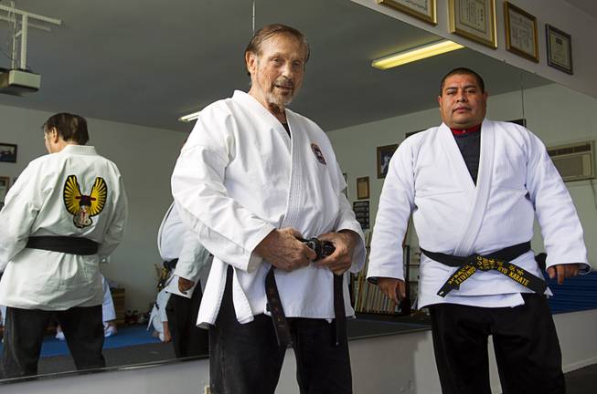 Karate master Dan Sawyer poses with instructor Mauro Felix, a fifth degree black belt, during a class at his home Sunday, Jan. 27, 2013. Sawyer teaches in a garage behind his home that has been converted into a karate dojo.