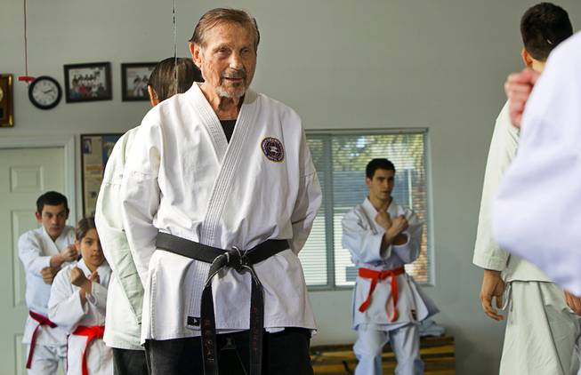 Karate master Dan Sawyer watches over a class at his home Sunday, Jan. 27, 2013. Sawyer teaches in a garage behind his home that has been converted into a karate dojo.